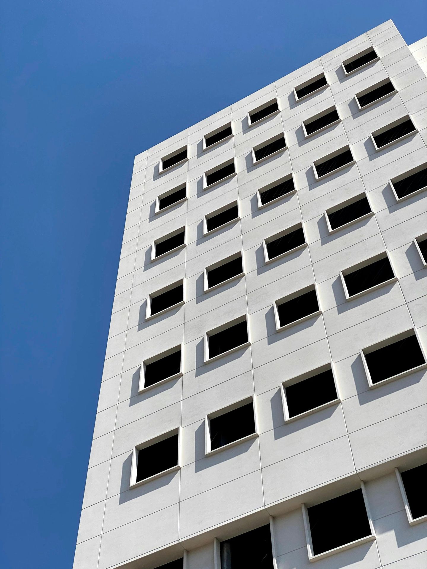 white concrete building under blue sky during daytime
